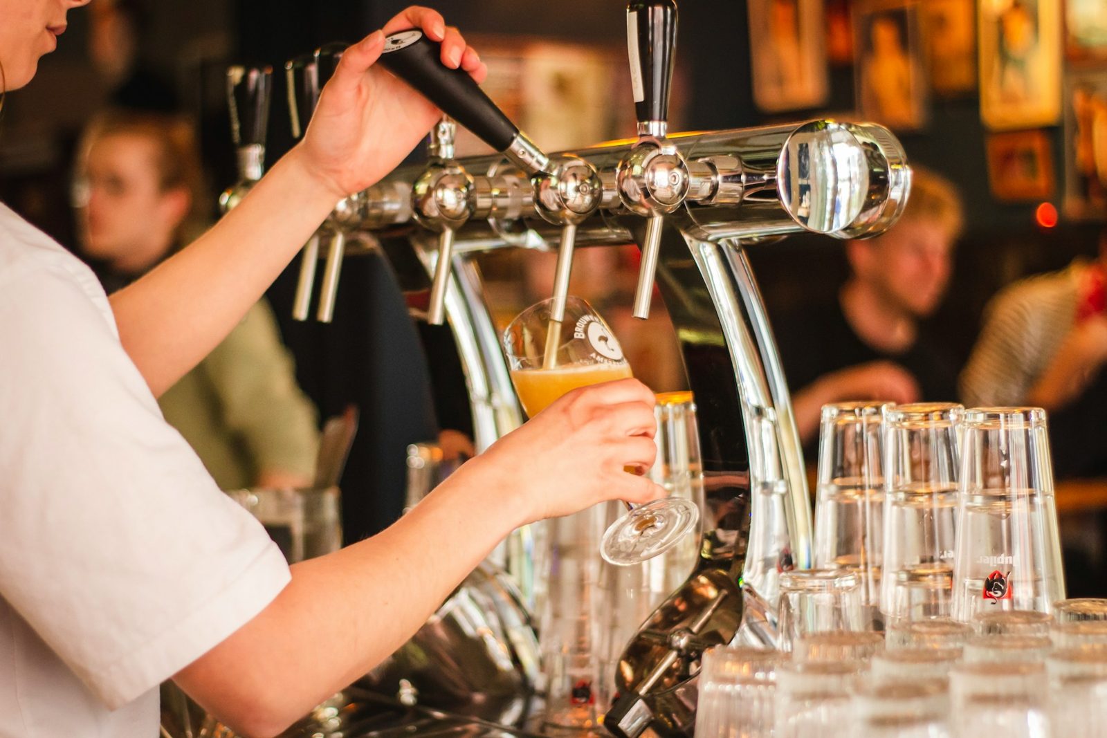 Bartender pouring a beer at the taps
